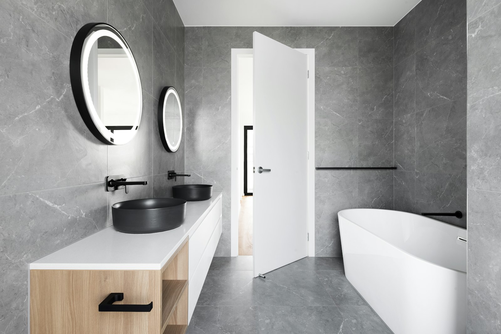 Bathroom vanity with a stone top and grey marble surround